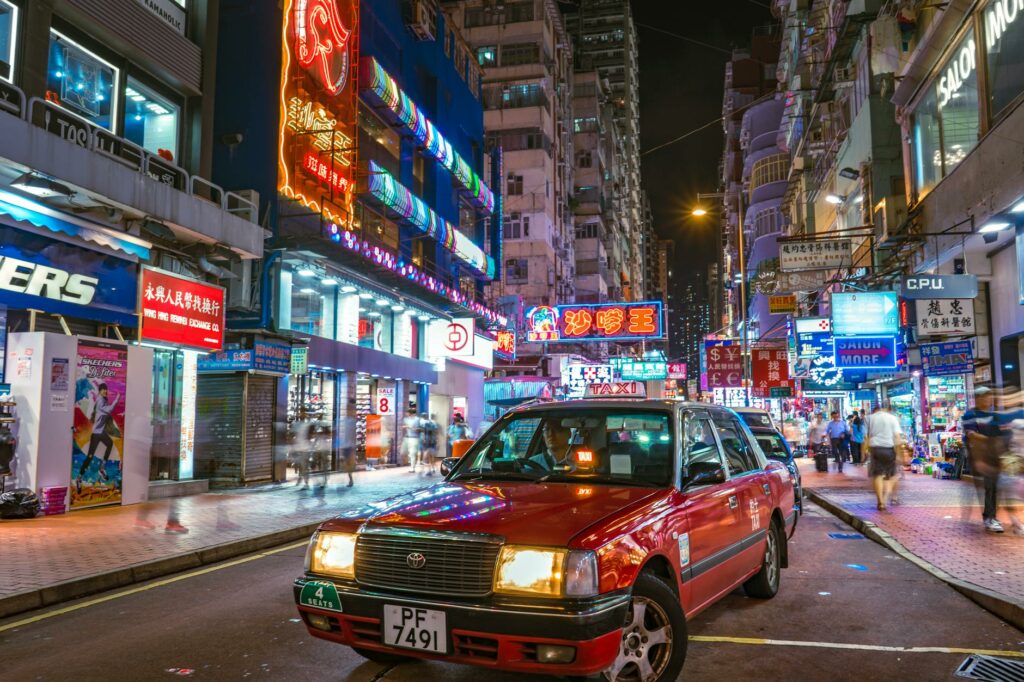 photo of a red taxi on a street