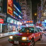 photo of a red taxi on a street